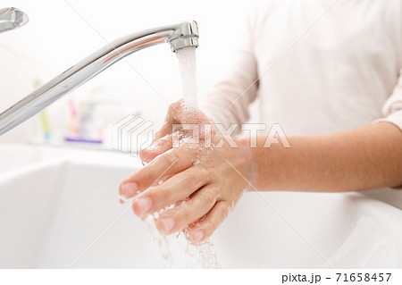 Washing hands in the bathroom. 71658457