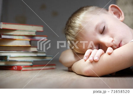 Boy fell asleep for school lessons. 71658520