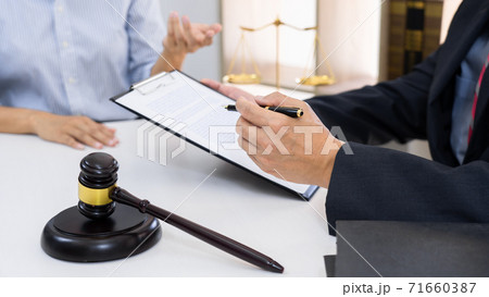 Professional Secretary lawyer working at his office signing contract Consultation of client from trust Law Firm, Attorneys Notary Law and Legal services concept 71660387