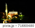 Pink Christmas decorations with candlels on a black background 71660480