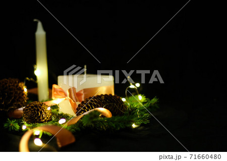 Pink Christmas decorations with candlels on a black background Pink Christmas decorations with candlels on a black background 71660480