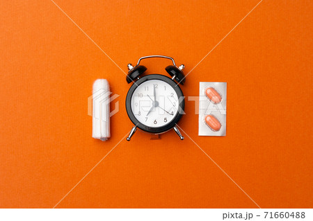 Female medical tampons and painkiller pills top view Female medical tampons and painkiller pills top view 71660488
