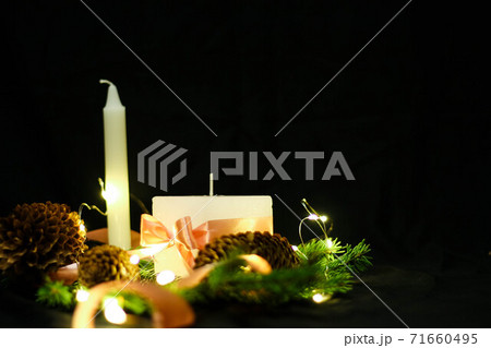 Pink Christmas decorations with candlels on a black background Pink Christmas decorations with candlels on a black background 71660495
