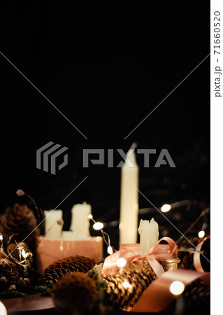 Pink Christmas decorations with candlels on a black background 71660520
