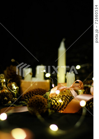 Pink Christmas decorations with candlels on a black background 71660534