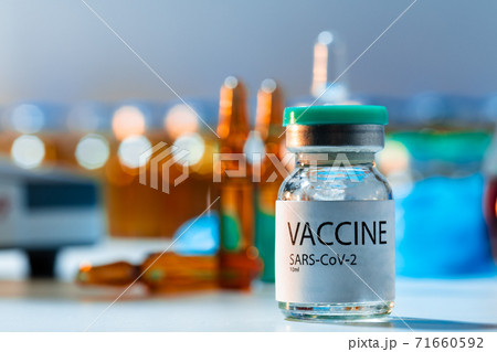 Vaccine vials of Sars-cov-2 on table in laboratory . Vaccine vials of Sars-cov-2 on table in laboratory . 71660592