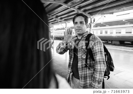 Persian tourist man and young Asian tourist woman together at the railway station Persian tourist man and young Asian tourist woman together at the railway station 71663973