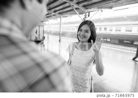 Persian tourist man and young Asian tourist woman together at the railway station Persian tourist man and young Asian tourist woman together at the railway station 71663975