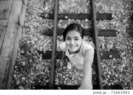 Young beautiful Asian tourist woman at the railway station Young beautiful Asian tourist woman at the railway station 71663983