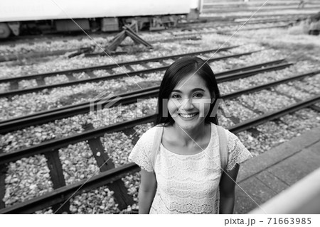 Young beautiful Asian tourist woman at the railway station Young beautiful Asian tourist woman at the railway station 71663985