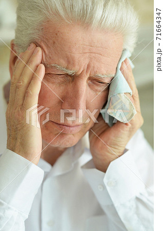 Portrait of sad sick senior man with headache Portrait of sad sick senior man with headache 71664347