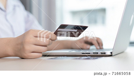 women use laptop to register online purchases using credit card payments, Convenience in the world of technology and the internet, Shopping online and banking online concept. 71665058