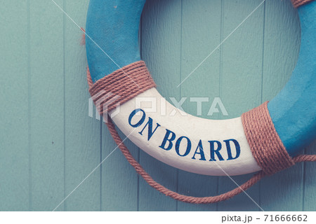 Life buoy with on board text decorate on wooden wall Life buoy with on board text decorate on wooden wall 71666662