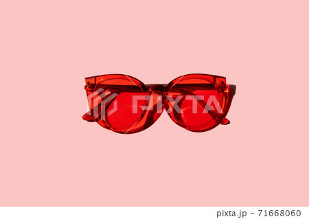 Trendy modern red sunglasses on pink background Trendy modern red sunglasses on pink background 71668060