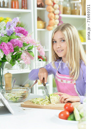 Portrait of cute girl preparing fresh salad Portrait of cute girl preparing fresh salad 71669351
