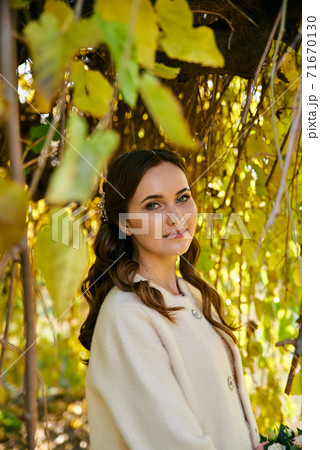 Warm autumn portrait of young pretty woman. 71670130