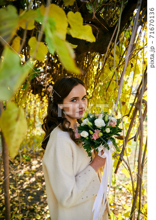 Warm autumn portrait of young pretty woman. 71670136