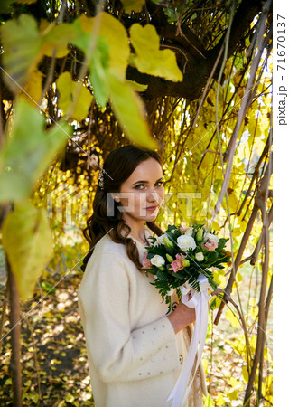 Warm autumn portrait of young pretty woman. 71670137