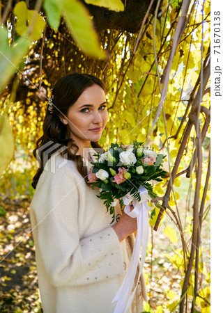 Warm autumn portrait of young pretty woman. 71670138