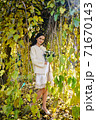 Warm autumn portrait of young pretty woman. 71670143