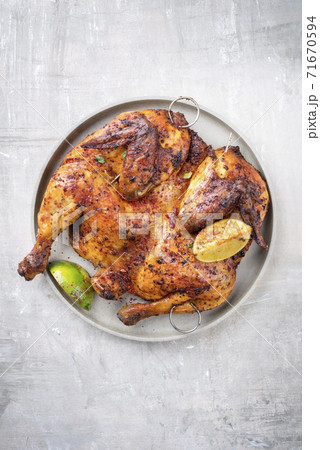 Traditional Chinese spatchcocked barbecue chicken with vegetable and soy sauce Traditional Chinese spatchcocked barbecue chicken with vegetable and soy sauce 71670594