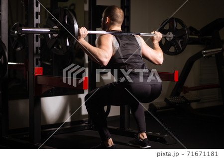 Sporty sexy men with great abdominal muscles in black sportswear working out in the gym. Sporty sexy men with great abdominal muscles in black sportswear working out in the gym. 71671181