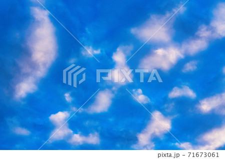 Stunning clouds in blue sky, illuminated by rays of sun at sunset to change summer weather. Soft focus, motion blur cloudscape background Stunning clouds in blue sky, illuminated by rays of sun at sunset to change summer weather. Soft focus, motion blur cloudscape background 71673061