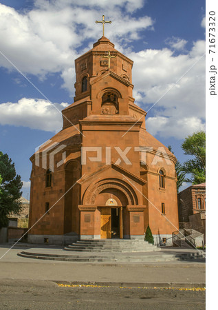 View of the facade of the Cathedral of the Holy Martyrs with a cross and the entrance under the arched portal of the bell tower in Gyumri View of the facade of the Cathedral of the Holy Martyrs with a cross and the entrance under the arched portal of the bell tower in Gyumri 71673320