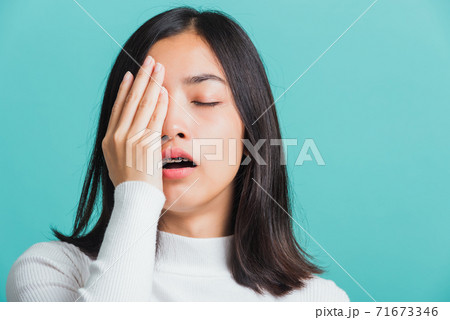 Portrait female bored yawning tired covering mouth with hand 71673346