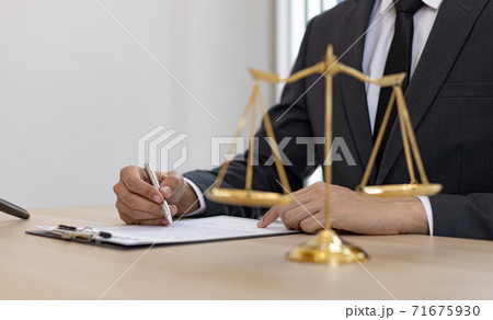 Judge or a lawyer works documents in the courtroom and analyze the various laws for justice and accuracy, Litigation and justice concept. Judge or a lawyer works documents in the courtroom and analyze the various laws for justice and accuracy, Litigation and justice concept. 71675930