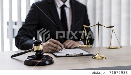 Judge or a lawyer works documents in the courtroom and analyze the various laws for justice and accuracy, Litigation and justice concept. Judge or a lawyer works documents in the courtroom and analyze the various laws for justice and accuracy, Litigation and justice concept. 71675988