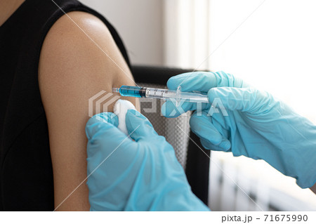 Doctor is vaccinating women with antibiotics or new antibodies to prevent the spread of the virus, Vaccination against communicable diseases concept 71675990