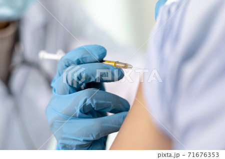 Doctor is vaccinating women with antibiotics or new antibodies to prevent the spread of the virus, Vaccination against communicable diseases concept 71676353