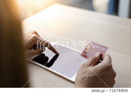 Businessman use tablet to register for security Online with a credit card to buy products online through application, Online shopping or Internet technology concept. Businessman use tablet to register for security Online with a credit card to buy products online through application, Online shopping or Internet technology concept. 71676809