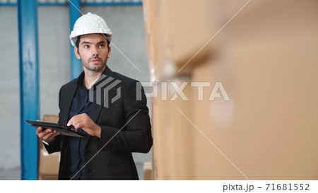Factory manager using tablet computer in warehouse or factory Factory manager using tablet computer in warehouse or factory 71681552