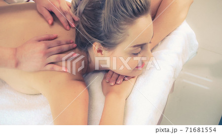 Woman gets back massage spa by massage therapist. Woman gets back massage spa by massage therapist. 71681554