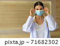 Female doctor wearing a mask 71682302