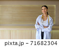 The female doctor was holding her arms smiling in the reception hall. 71682304
