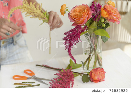 Woman making floral arrangement Woman making floral arrangement 71682926
