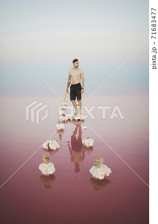 Ukraine, Crimea, Man standing on salt crystal in salt lake Ukraine, Crimea, Man standing on salt crystal in salt lake 71683477