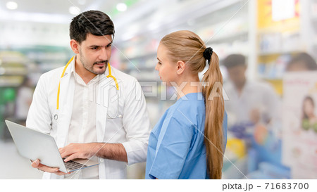 Doctors at hospital working with another doctor. Doctors at hospital working with another doctor. 71683700