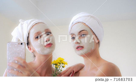 Beautiful woman having a facial treatment at spa. Beautiful woman having a facial treatment at spa. 71683703