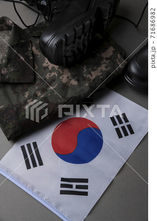 Military symbols concep, South Korean flag and folded military uniform 08 Military symbols concep, South Korean flag and folded military uniform 08 71686982
