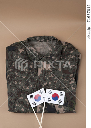 Military symbols concep, South Korean flag and folded military uniform 36 Military symbols concep, South Korean flag and folded military uniform 36 71687012