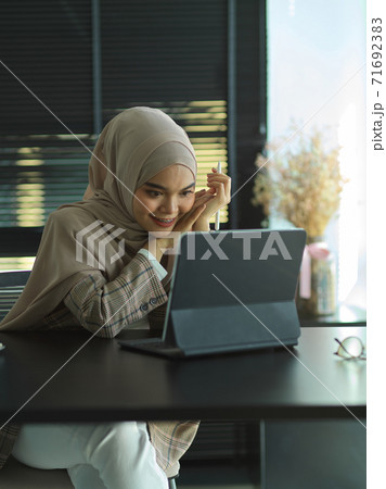 Muslim businesswoman reading informations on digital tablet in office room 71692383
