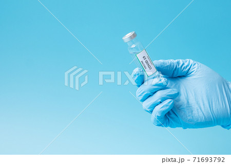 COVID-19 Vaccine vial against Coronavirus infection in hand of doctor with Nitrile Glove in hospital laboratory. Medical, health, Vaccination and immunization concept 71693792