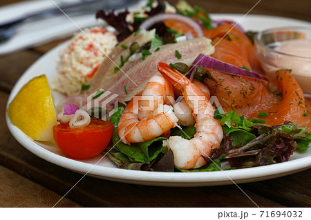 Cold and smoked seafood platter on wooden table Cold and smoked seafood platter on wooden table 71694032