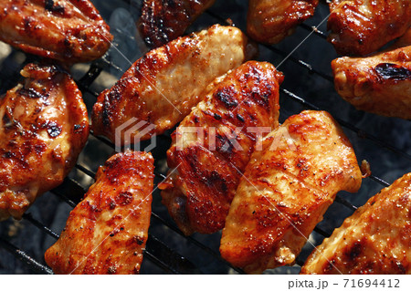Chicken buffalo wings cooked on BBQ grill Chicken buffalo wings cooked on BBQ grill 71694412