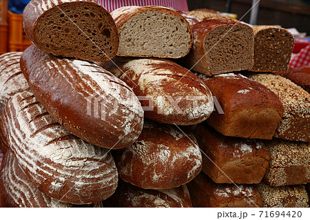 Assorted fresh bread loaves on retail display Assorted fresh bread loaves on retail display 71694420
