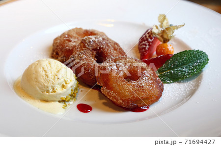 Portion of deep fried battered sweet apple rings 71694427